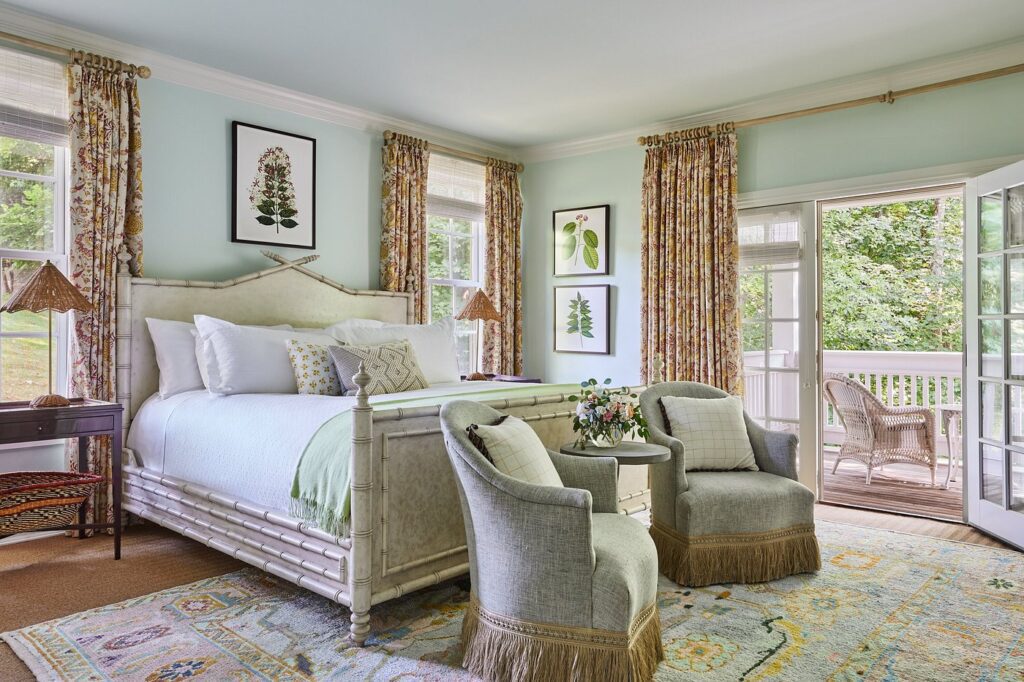 Elegant guest room at Mayflower Inn with four-poster bed and garden views