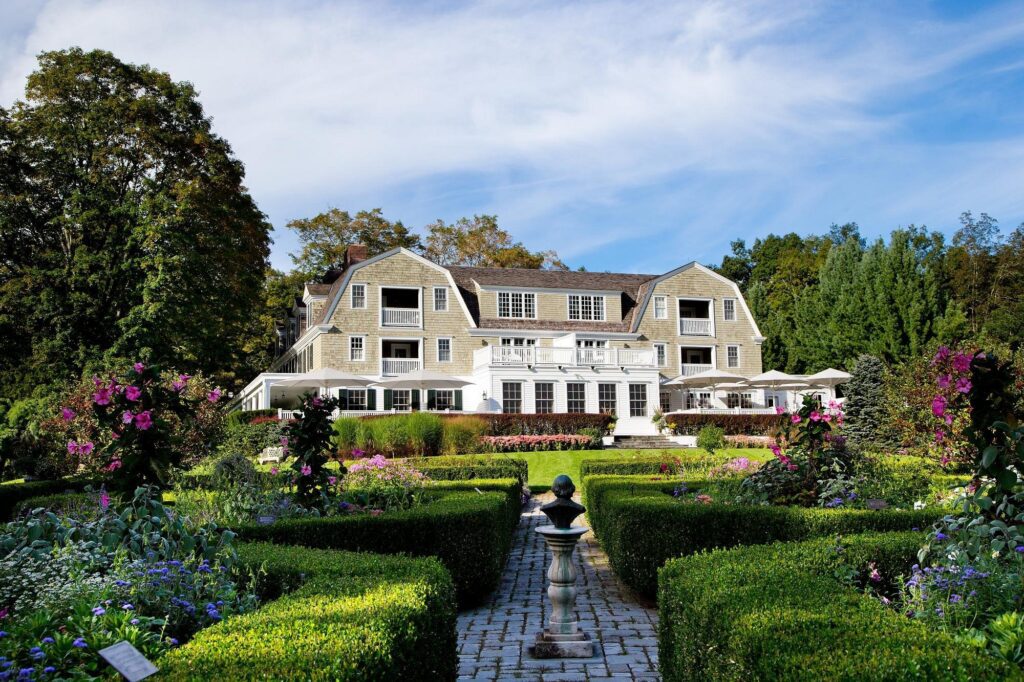 Mayflower Inn & Spa exterior surrounded by manicured gardens and lush seasonal blooms