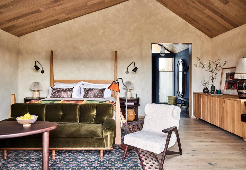 Spacious luxury guest room at Wildflower Farms with floor-to-ceiling windows and refined, nature-inspired décor