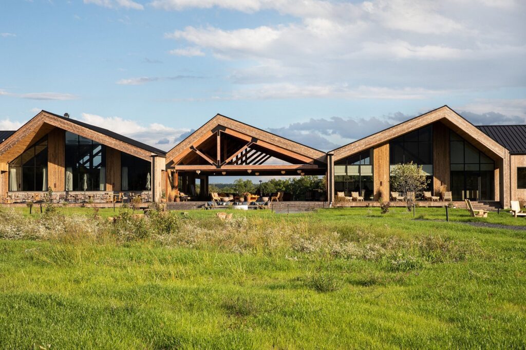Warm communal gathering space with modern fire pit and plush lounge seating at Wildflower Farms